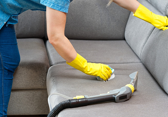 Professional sofa cleaning service being performed in a home
